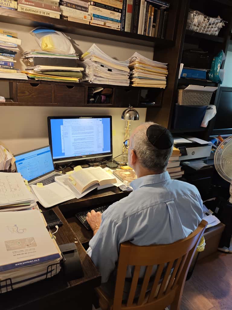 Eric Brand writing at a desk